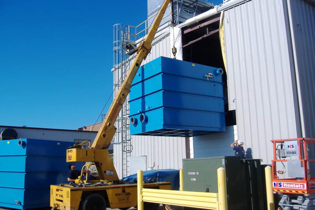 A crane lifting a container into a cooling tower during a Process Cooling project.